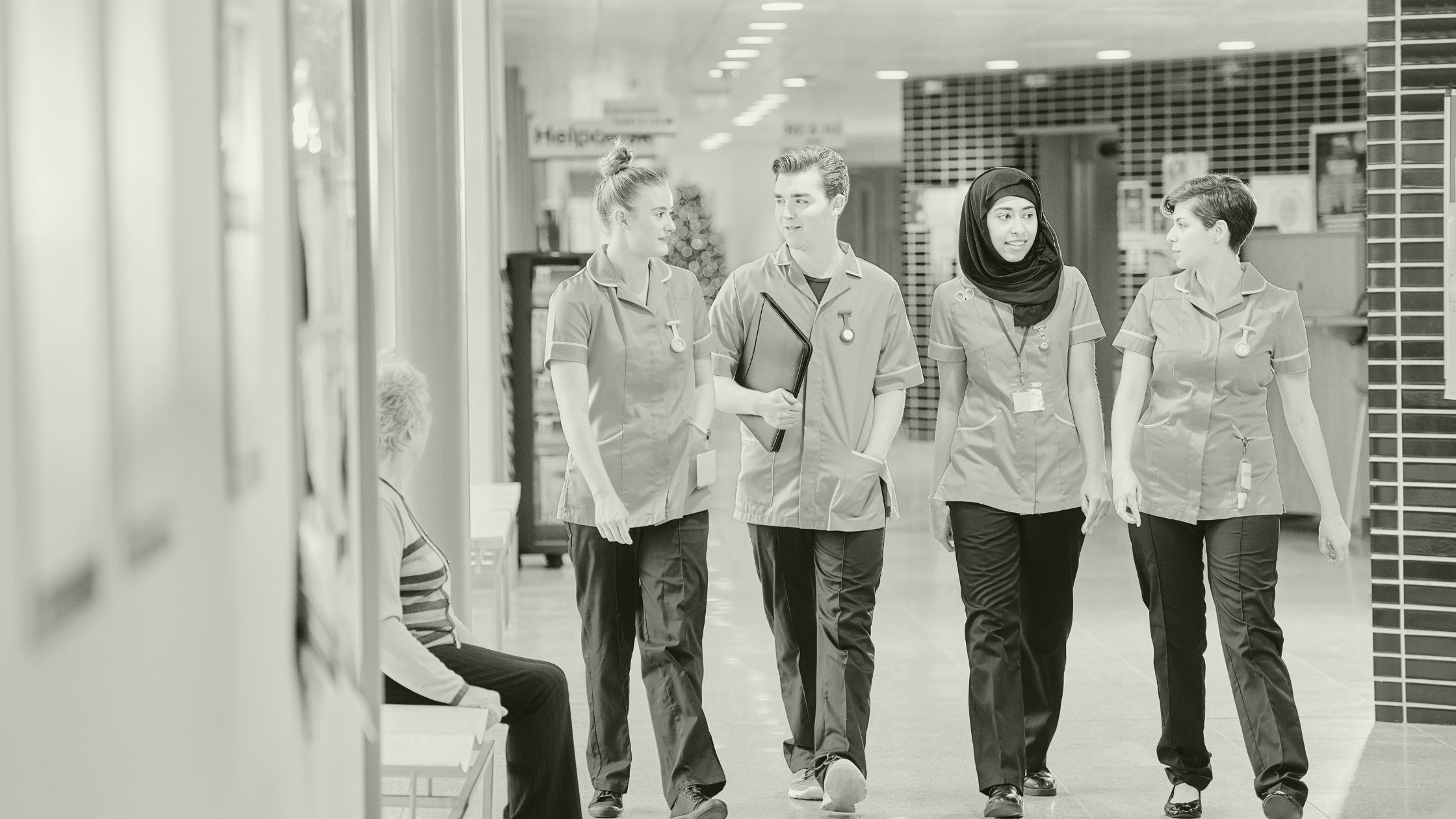 Primary Care healthcare workers walking together in a hospital, reflecting teamwork and career growth in 2025.