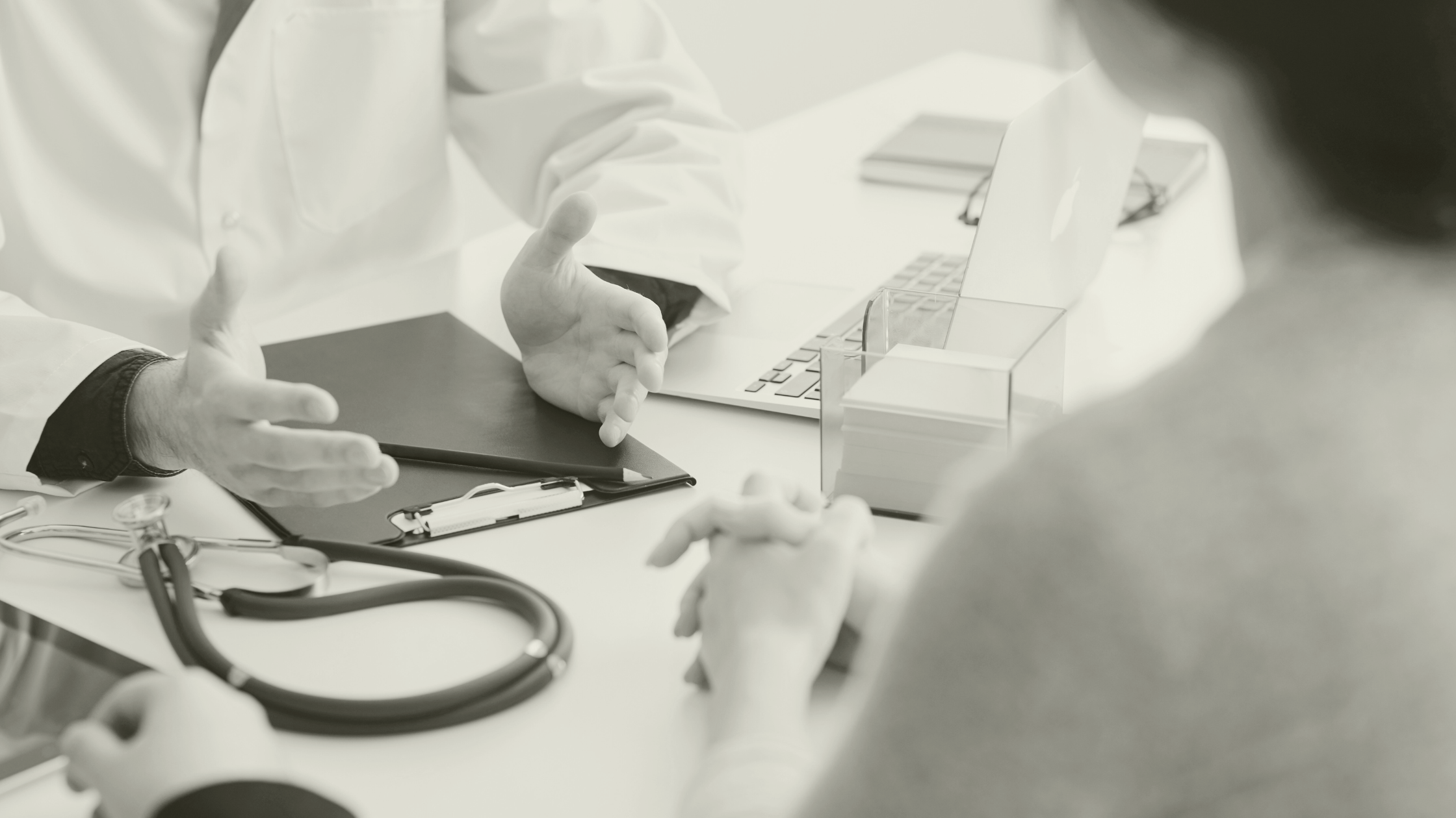 Two healthcare professionals reviewing patient notes in a GP surgery, highlighting the importance of the right clinical hire in primary care.