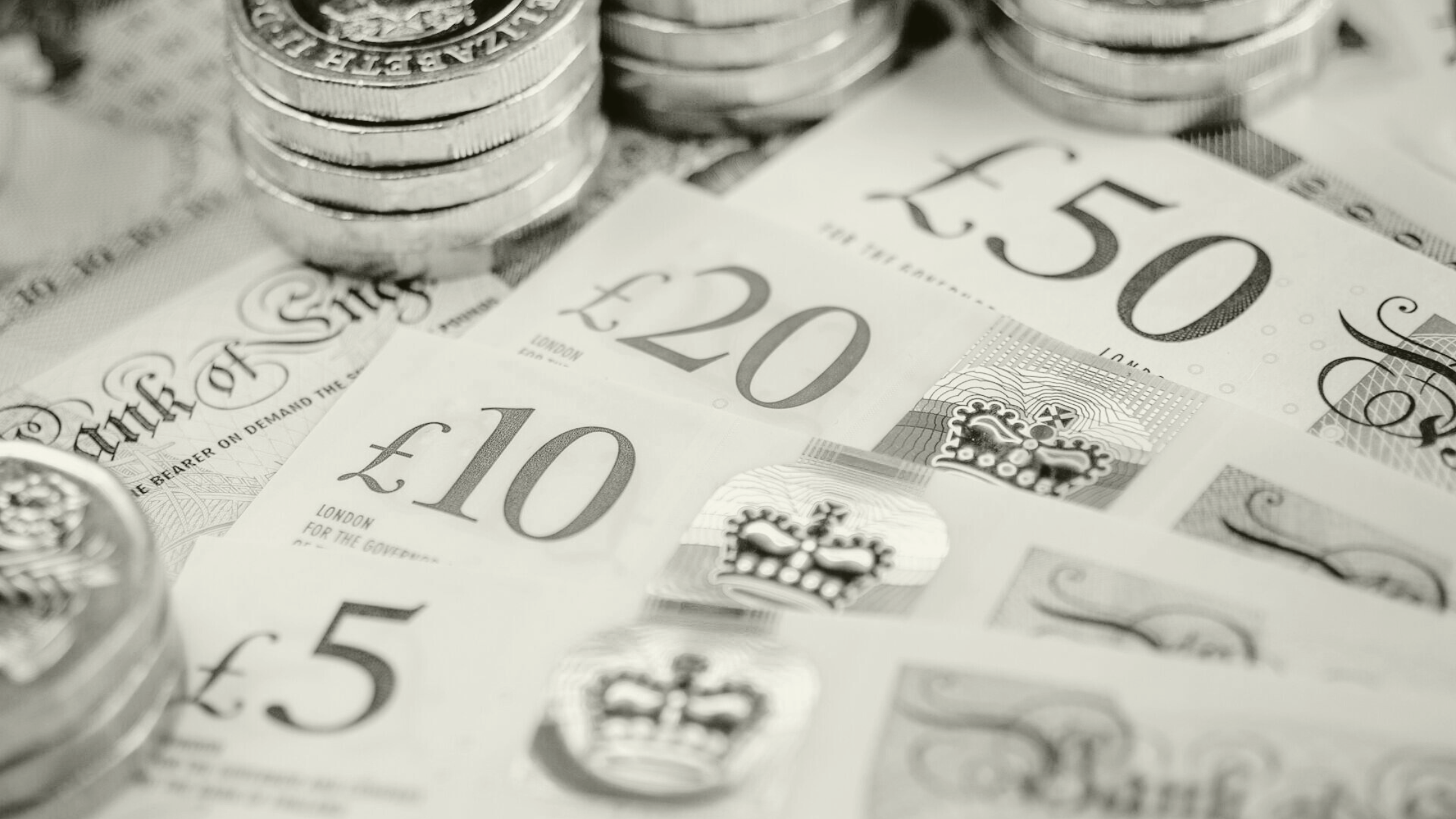 British pound notes and coins representing NHS funding increases.