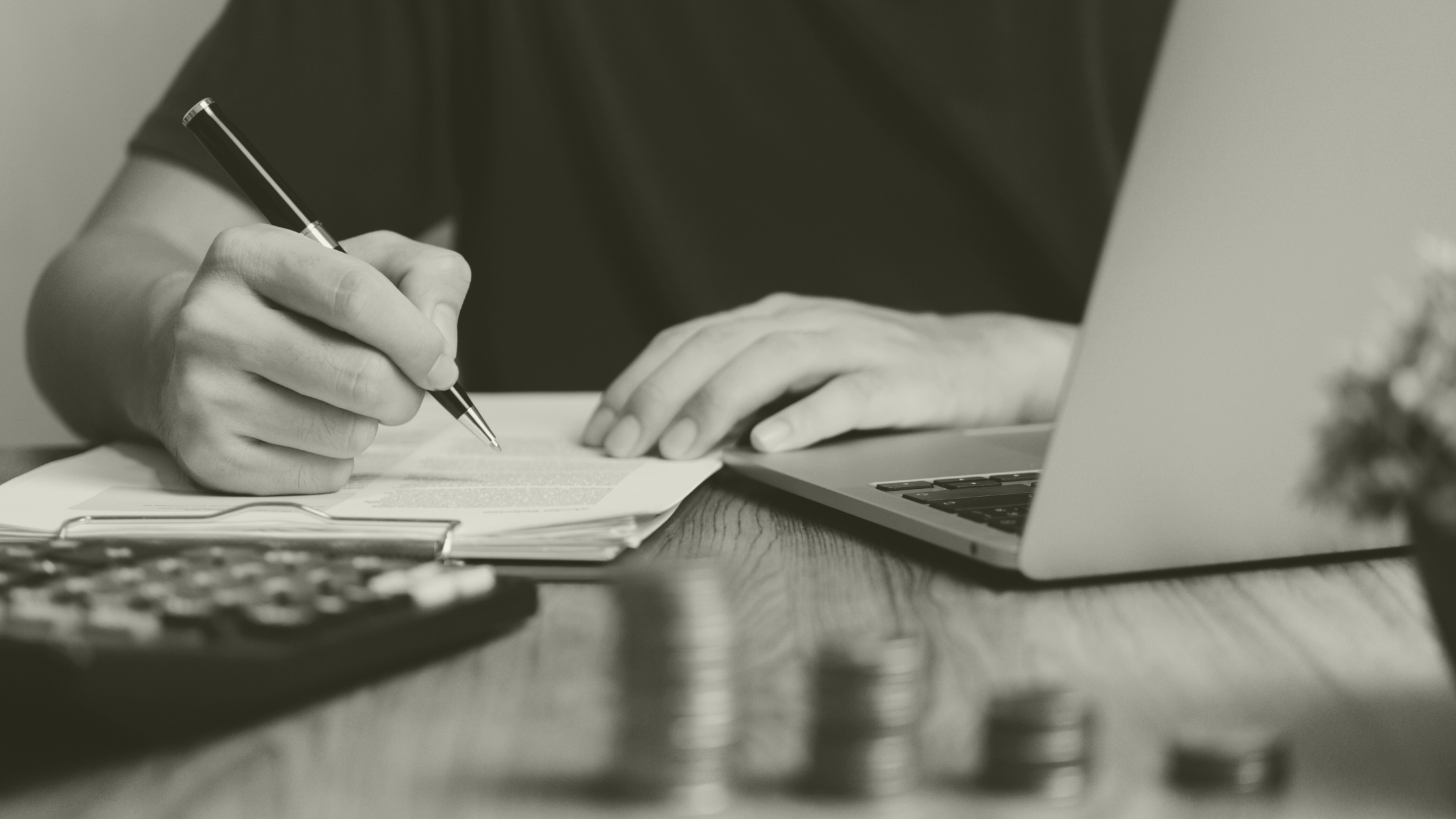 Person reviewing funding documents at a desk, representing ARRS planning and recruitment strategy for primary care