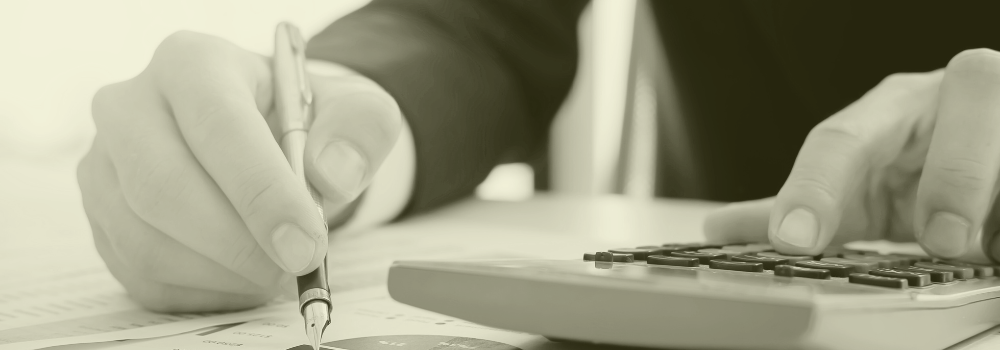 Person reviewing agency costs with a calculator and financial report