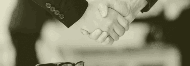 Close-up handshake symbolising trust, partnership, and transparent primary care recruitment with Vela Medical Group.