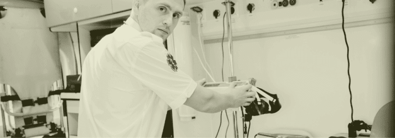 A Paramedic Practitioner organising medical equipment inside an ambulance, representing the transition of paramedics into primary care and their growing role in supporting GP services across the UK.