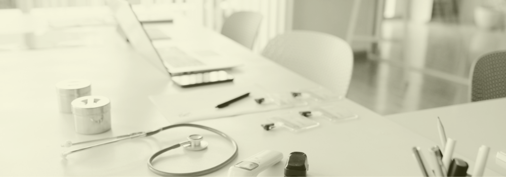 A stethoscope, laptop, and medical equipment on a desk symbolising planning, recruitment, and strategic workforce development in primary care for 2026 and beyond.