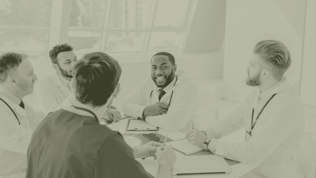 Primary Care clinicians in a PCN workforce planning meeting discussing ARRS roles, GP workload and multidisciplinary team structure in 2026