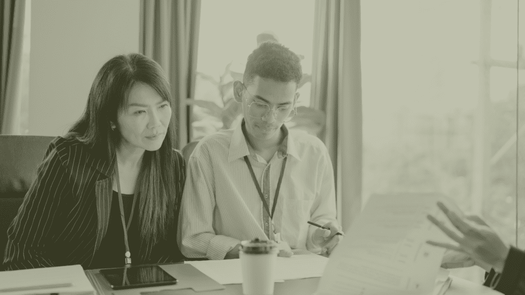 GP Practice Manager reviewing operational plans with colleague in primary care setting UK recruitment