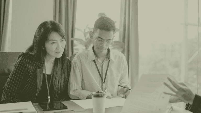 GP Practice Manager reviewing operational plans with colleague in primary care setting UK recruitment