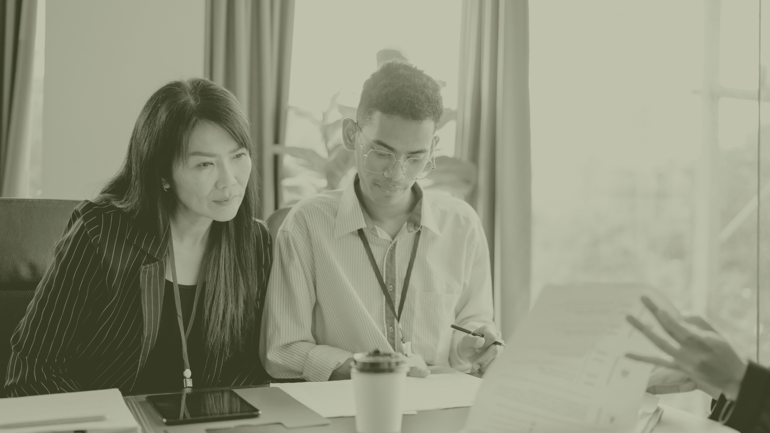 GP Practice Manager reviewing operational plans with colleague in primary care setting UK recruitment